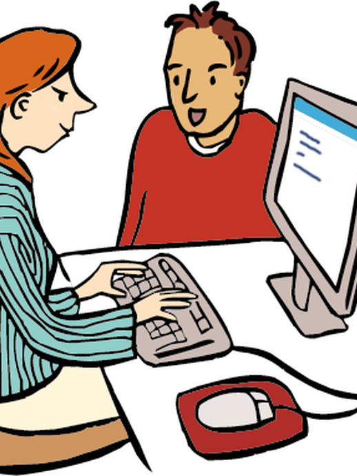 Eine Assistentin hilft einer Person am Computer (öffnet vergrößerte Bildansicht)